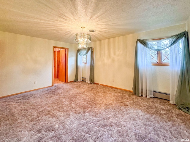 carpeted empty room featuring a textured ceiling, an inviting chandelier, and a baseboard heating unit