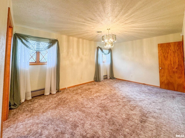 carpeted empty room with a baseboard heating unit, a textured ceiling, and an inviting chandelier