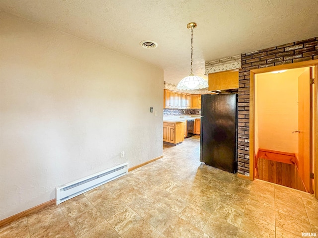 kitchen featuring tasteful backsplash, a textured ceiling, hanging light fixtures, black refrigerator, and a baseboard radiator