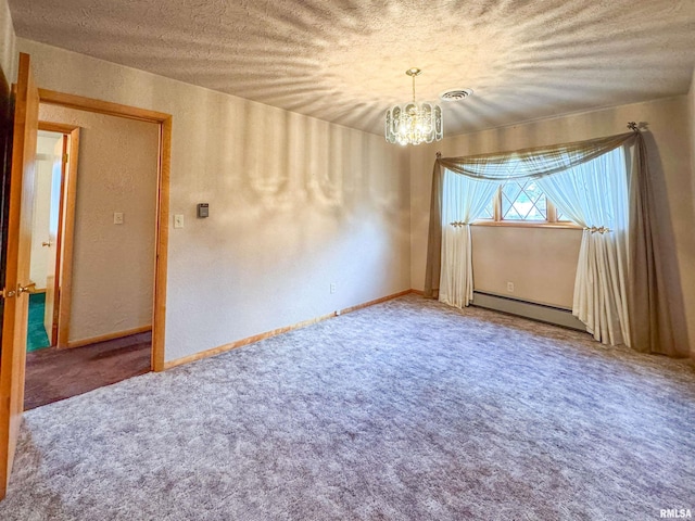 spare room featuring baseboard heating, a textured ceiling, and an inviting chandelier