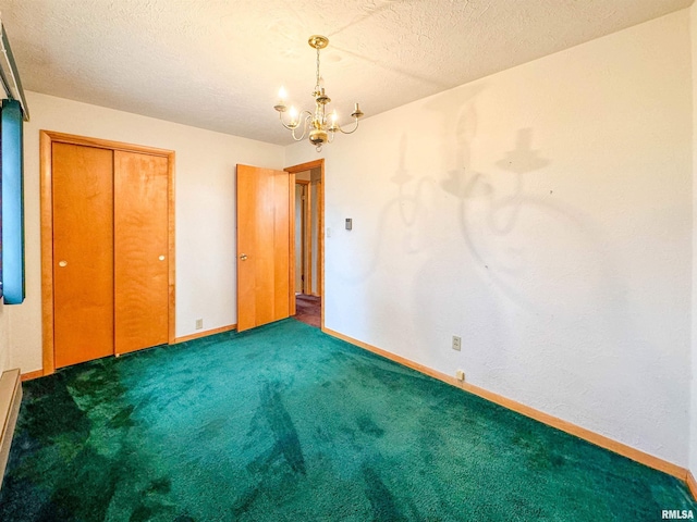 unfurnished bedroom featuring a closet, an inviting chandelier, a textured ceiling, and dark carpet