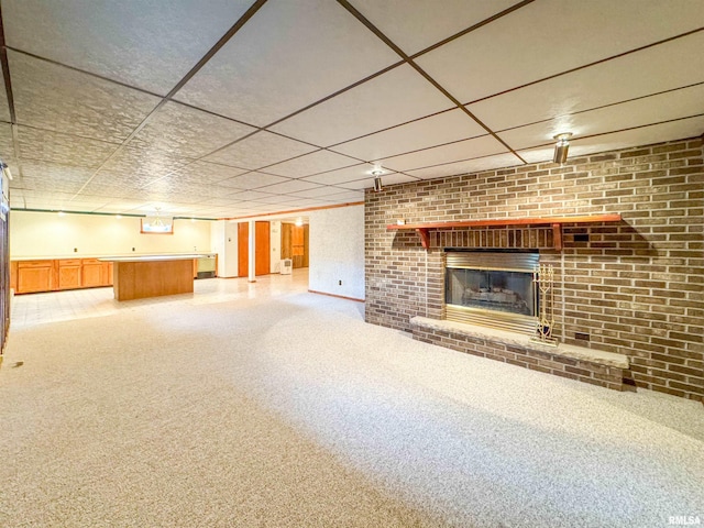 unfurnished living room with a fireplace and carpet