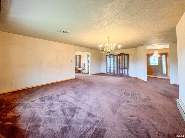 carpeted spare room with an inviting chandelier and a textured ceiling