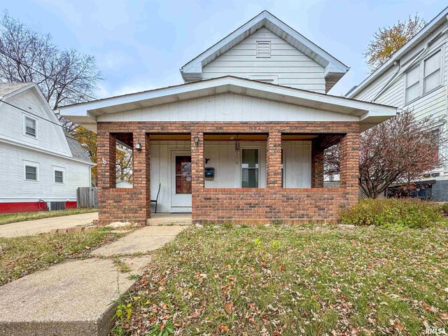 bungalow-style house with central air condition unit and a porch