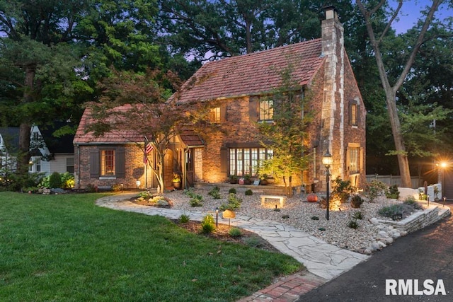 tudor home with a front yard