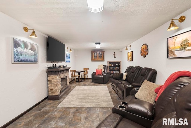 living room with a textured ceiling and a fireplace