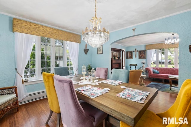 dining space with baseboard heating, dark hardwood / wood-style floors, and crown molding