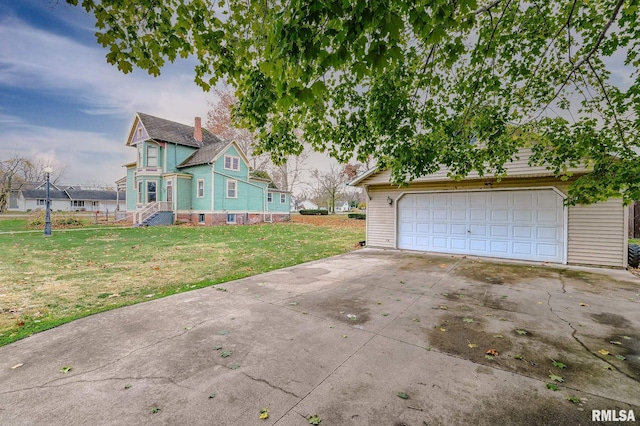 view of home's exterior featuring a garage and a yard