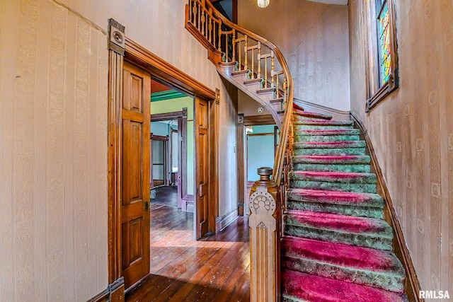 staircase with hardwood / wood-style flooring