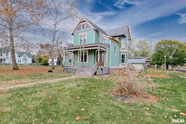 victorian house with a porch and a front lawn