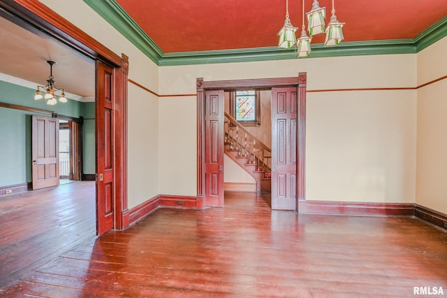 interior space with ornamental molding and hardwood / wood-style floors