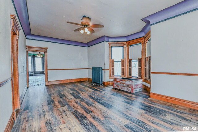 unfurnished room with dark hardwood / wood-style flooring and ceiling fan