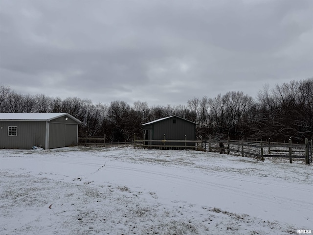 yard covered in snow featuring an outdoor structure