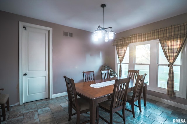 dining space with an inviting chandelier