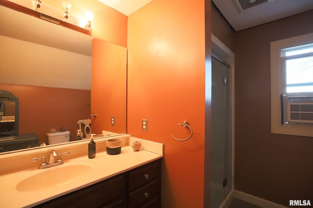 bathroom with vanity, toilet, an enclosed shower, and cooling unit