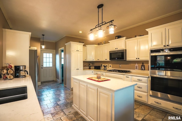 kitchen featuring white cabinets, pendant lighting, and appliances with stainless steel finishes