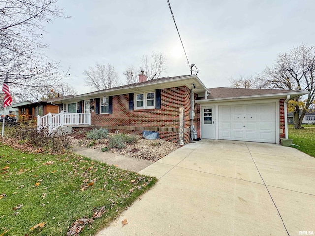 ranch-style home with a garage, a front lawn, and covered porch