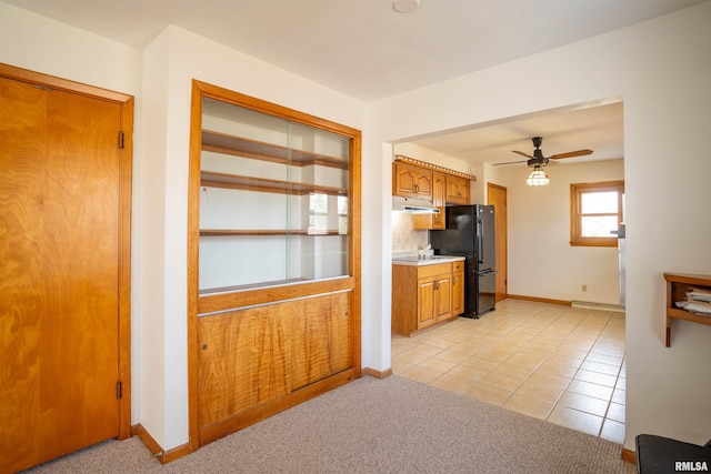 kitchen featuring tasteful backsplash, black appliances, ceiling fan, and light tile patterned flooring