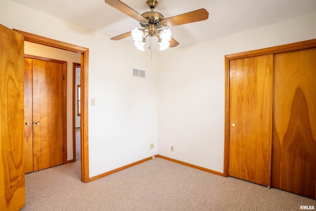 unfurnished bedroom with light carpet, a closet, and ceiling fan