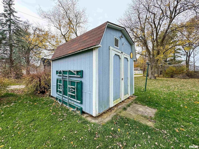 view of outbuilding with a yard