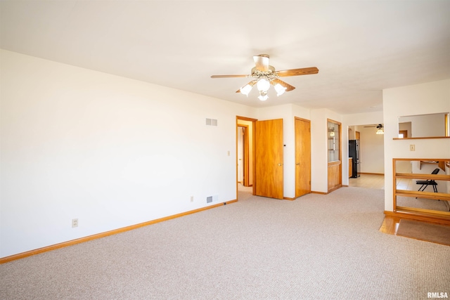 carpeted empty room featuring ceiling fan