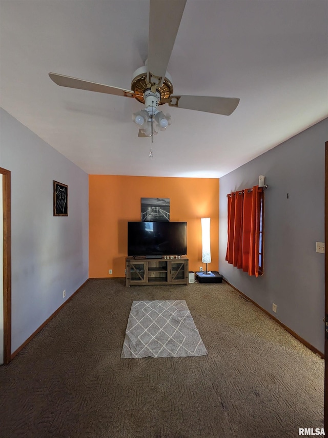 unfurnished living room featuring ceiling fan and dark colored carpet