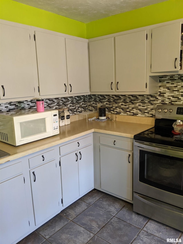 kitchen with white cabinets, decorative backsplash, and stainless steel range with electric cooktop