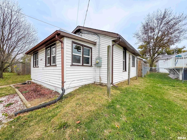 view of side of property with a lawn