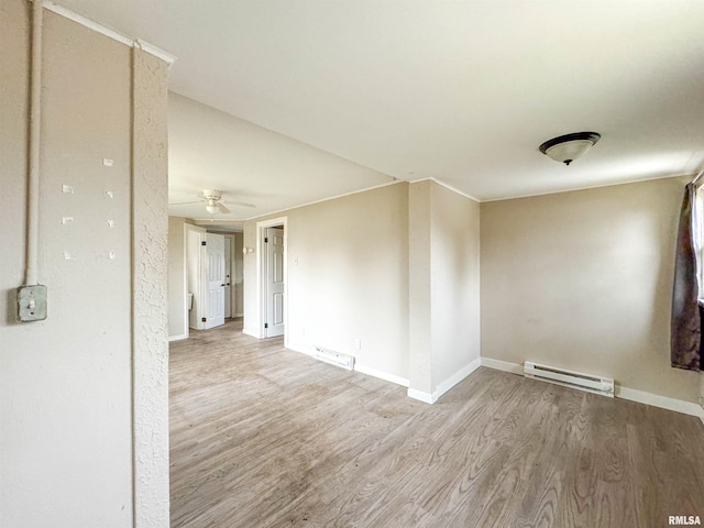 unfurnished room with light hardwood / wood-style floors, ceiling fan, and a baseboard heating unit