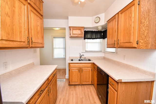 kitchen with decorative backsplash, dishwasher, light hardwood / wood-style floors, and sink