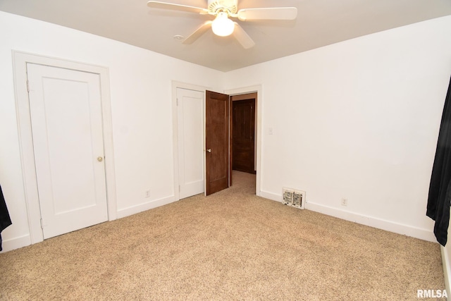 unfurnished bedroom featuring ceiling fan and carpet