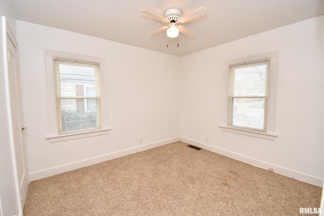 unfurnished room featuring ceiling fan and light colored carpet