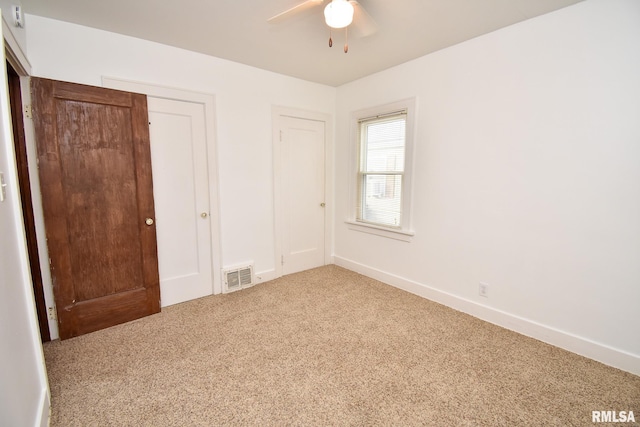 unfurnished bedroom with carpet floors and ceiling fan