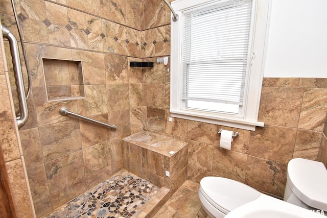 bathroom featuring toilet and tiled shower