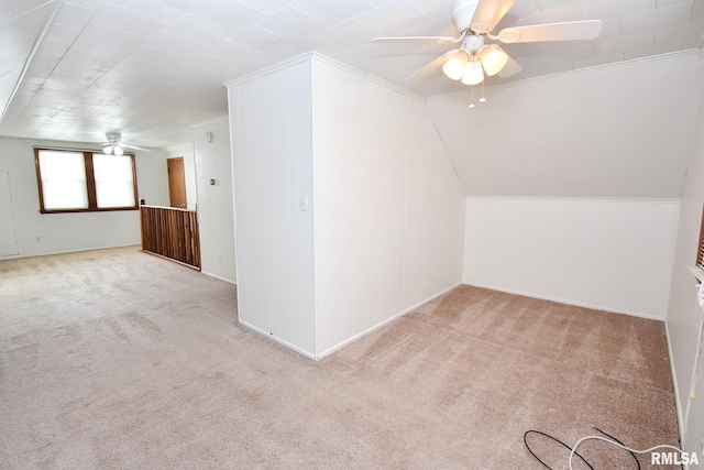 additional living space featuring light carpet, ceiling fan, and lofted ceiling