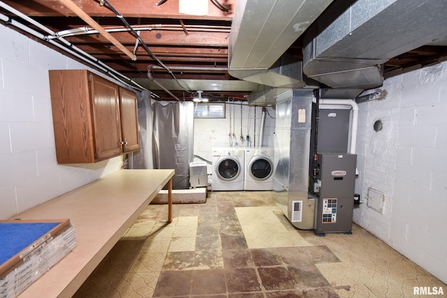 laundry area featuring separate washer and dryer and heating unit