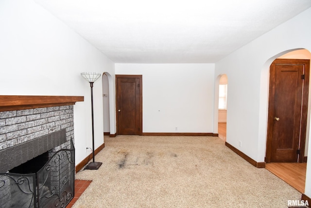 living room with light colored carpet and a fireplace