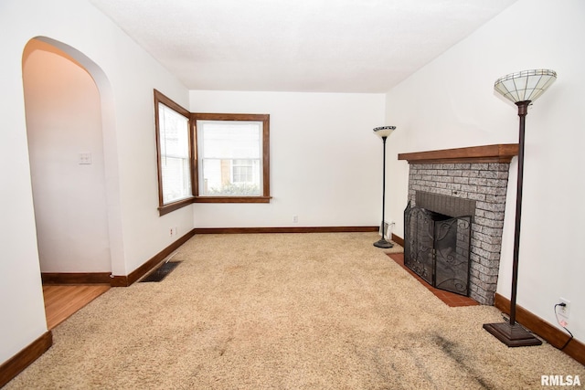 carpeted living room with a fireplace