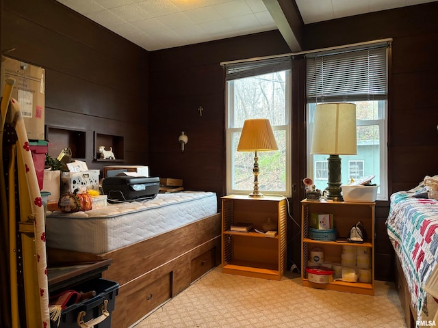 bedroom featuring wooden walls