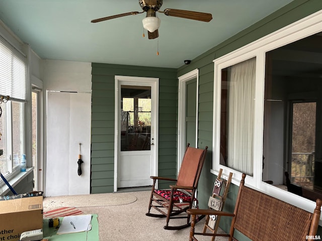 sunroom with a wealth of natural light and ceiling fan