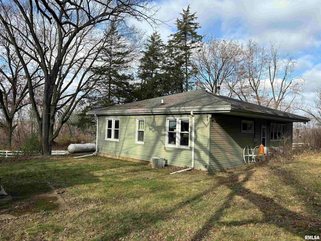 exterior space featuring a lawn and cooling unit