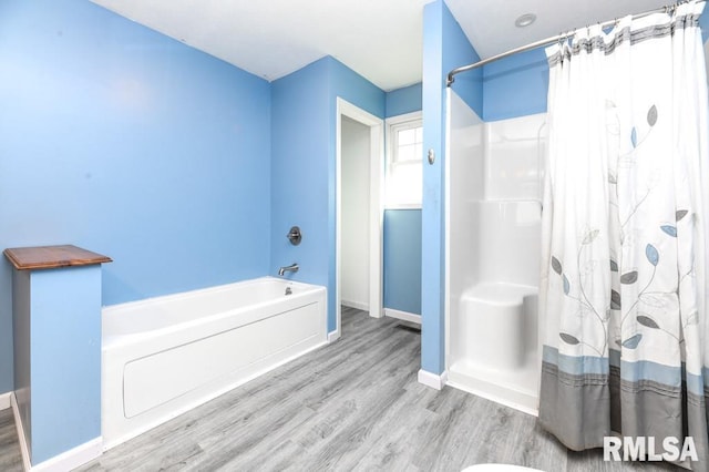 bathroom featuring hardwood / wood-style flooring and shower / bath combo with shower curtain