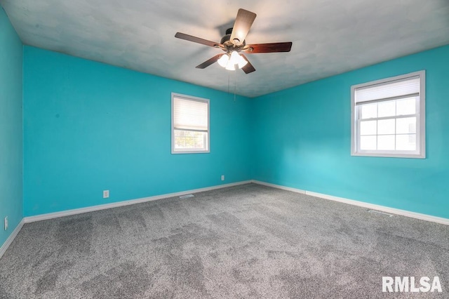 carpeted empty room featuring ceiling fan