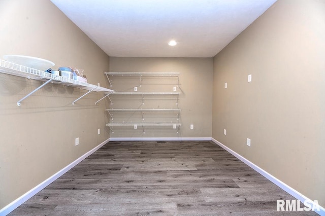 spacious closet featuring hardwood / wood-style floors