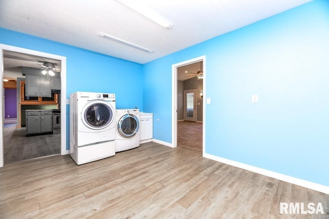 washroom with washer and clothes dryer, cabinets, ceiling fan, and light wood-type flooring