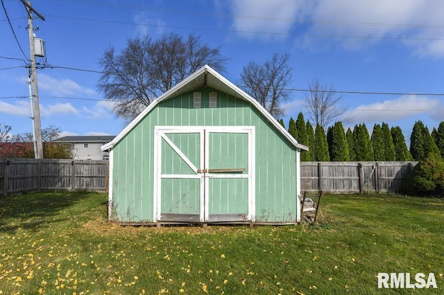 view of outbuilding featuring a lawn