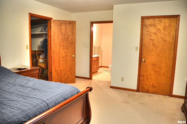 bedroom with light carpet and a closet