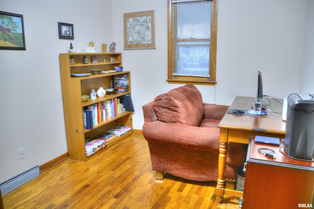 office area featuring wood-type flooring and a baseboard radiator