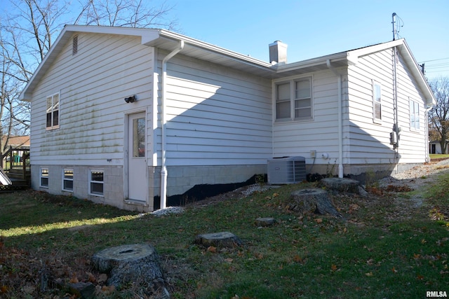 view of property exterior featuring a yard and central AC unit