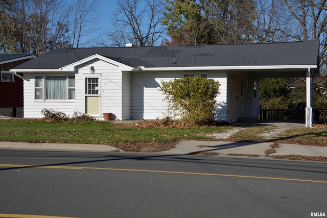 ranch-style home featuring a carport